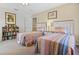 Bedroom featuring two beds, a bookshelf, decorative wall art, and a window that provides natural light at 107 Troon Cir, Davenport, FL 33897