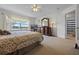 Spacious carpeted bedroom features a large window with views, and an en suite bathroom for convenience at 107 Troon Cir, Davenport, FL 33897