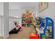 Second view of the upstairs bonus room/playroom with toys, arcade game, and tv at 107 Troon Cir, Davenport, FL 33897