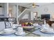 Close up on breakfast nook table with plates and a bowl of fruit at 107 Troon Cir, Davenport, FL 33897