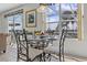 Bright breakfast nook with a glass table and views of the lanai at 107 Troon Cir, Davenport, FL 33897