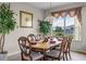 Formal dining room featuring a wooden table, seating for six, and a large window overlooking the backyard at 107 Troon Cir, Davenport, FL 33897