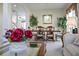 Open-concept dining room with decorative plants and chandelier at 107 Troon Cir, Davenport, FL 33897
