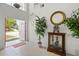 Bright and inviting foyer with tile flooring, a tall plant, and an open view into the home at 107 Troon Cir, Davenport, FL 33897