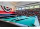 Well-equipped game room with a pool table, ping pong table, and patriotic decor, ideal for Gathering entertainment at 107 Troon Cir, Davenport, FL 33897