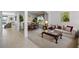 Open-concept living and dining area featuring a large window and classic furniture at 107 Troon Cir, Davenport, FL 33897