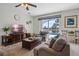 Living room with comfortable seating, dark wood furniture, and large window view at 107 Troon Cir, Davenport, FL 33897