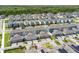 A modern community boasts homes with garages and solar panels, surrounded by lush greenery at 11473 Listening Dr, Orlando, FL 32832