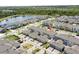 A serene view of a lakeside community featuring homes with modern architecture and lush greenery at 11473 Listening Dr, Orlando, FL 32832