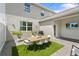 Outdoor patio with dining set, grill, brick pavers, and string lights creates a welcoming entertainment space at 11473 Listening Dr, Orlando, FL 32832