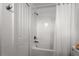 A full white bathroom with a shower-tub combo and a handy closet at 11473 Listening Dr, Orlando, FL 32832