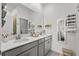 Modern bathroom featuring double sinks, vanity, and a decorative mirror at 11473 Listening Dr, Orlando, FL 32832