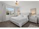 Bright bedroom with a large window, neutral decor, and carpet flooring at 11473 Listening Dr, Orlando, FL 32832