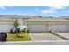 View of the garage of this home, with brick pavers and landscaping at 11473 Listening Dr, Orlando, FL 32832