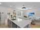 Open-concept kitchen and living area with a large island and modern appliances at 11473 Listening Dr, Orlando, FL 32832
