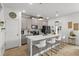 Modern kitchen with an island, white countertops, gray cabinets, and stainless steel appliances at 11473 Listening Dr, Orlando, FL 32832