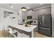 Stylish kitchen featuring gray cabinets, an island with seating, and modern fixtures at 11473 Listening Dr, Orlando, FL 32832