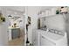 Laundry room with washer, dryer, and storage shelving at 11473 Listening Dr, Orlando, FL 32832
