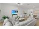 Bright living room featuring modern furnishings, neutral decor, and a large screen television at 11473 Listening Dr, Orlando, FL 32832
