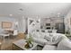 Open concept living space with island, kitchen, dining area, and comfortable seating at 11473 Listening Dr, Orlando, FL 32832