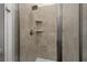 Tiled shower stall with shower head and built-in shelves at 11473 Listening Dr, Orlando, FL 32832