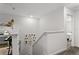 Open staircase with neutral walls leads to a cozy bedroom, with a gallery of Gathering photos adding personal charm at 11473 Listening Dr, Orlando, FL 32832