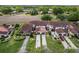 Aerial shot of well-maintained townhouses with private driveways and lush landscaping at 117 Coventry Ln, Haines City, FL 33844