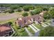 Overhead view of townhouses surrounded by trees and greenery at 117 Coventry Ln, Haines City, FL 33844