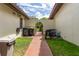 Backyard patio with a barbecue grill and trash bins at 117 Coventry Ln, Haines City, FL 33844