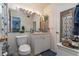 Compact bathroom featuring a single sink vanity, toilet, and framed mirror with vanity lights at 117 Coventry Ln, Haines City, FL 33844