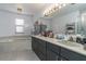 Well-lit bathroom with a large vanity, ample counter space, and a luxurious bathtub at 117 Coventry Ln, Haines City, FL 33844