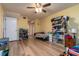 Spacious bedroom with wood floors, ceiling fan and a closet with sliding mirror doors at 117 Coventry Ln, Haines City, FL 33844