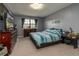 Bright bedroom with TV on dresser, side tables, and a window with curtains for natural light at 117 Coventry Ln, Haines City, FL 33844