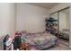 Cozy bedroom with a closet, shelf with items, and a comfy-looking bed with a colorful quilt at 117 Coventry Ln, Haines City, FL 33844