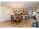 Dining room with wood look floors located adjacent to kitchen at 117 Coventry Ln, Haines City, FL 33844
