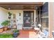 Front porch of a home with potted plants and chairs, creating a cozy and inviting outdoor space at 117 Coventry Ln, Haines City, FL 33844