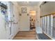 Inviting home entryway with a bench and decor, opening to a half bathroom and staircase at 117 Coventry Ln, Haines City, FL 33844