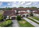 Overhead shot of multi-Gathering homes showcasing garages and neatly trimmed hedges at 117 Coventry Ln, Haines City, FL 33844