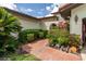 Charming home entrance with lush plants, and a stone walkway leading to an inviting gated entry at 117 Coventry Ln, Haines City, FL 33844