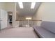 Second story hallway with two skylights, couch, and railing overlooking the living room below at 117 Coventry Ln, Haines City, FL 33844