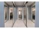 Mirrored hallway with closet doors reflecting views of bathrooms, creating a spacious feel at 117 Coventry Ln, Haines City, FL 33844