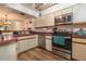 Well lit kitchen features stainless steel appliances and wood look flooring at 117 Coventry Ln, Haines City, FL 33844