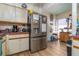 Kitchen with stainless steel refrigerator and wood look floors at 117 Coventry Ln, Haines City, FL 33844