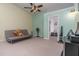 Neutral carpet and light walls create a bright space, complemented by a ceiling fan and light fixture at 117 Coventry Ln, Haines City, FL 33844