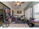 Covered back patio with seating area, brick floors and ceiling fan at 117 Coventry Ln, Haines City, FL 33844