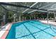Inviting community pool with screened enclosure and lounge chairs for relaxing and enjoying the outdoors at 117 Coventry Ln, Haines City, FL 33844