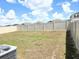 Large backyard with a pristine white fence, offering ample space for outdoor activities and privacy at 1241 Denali Dr, Winter Haven, FL 33881