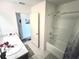 Bright bathroom features a large mirror, white cabinetry, and a shower-tub combination for a refreshing experience at 1241 Denali Dr, Winter Haven, FL 33881