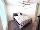 Cozy bedroom featuring a ceiling fan and a comfortable bed with a floral comforter and a closet at 1241 Denali Dr, Winter Haven, FL 33881
