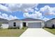 Well-maintained home features a two-car garage and manicured lawn at 1241 Denali Dr, Winter Haven, FL 33881